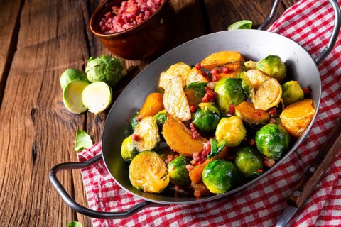 Brussels sprouts potato pan with bacon in a rustic style