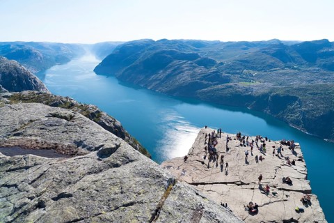 PULPIT ROCK, NORWAY, JULY 26, 2018: Unknown tourists enjoying the stunning view on Pulpit Rock. The
