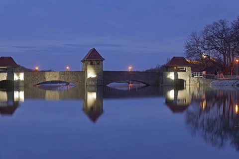 The illuminated Palmengarten weir in the blue hour. Leipzig, Saxony, Germany