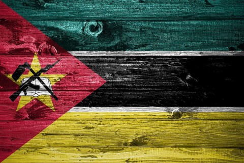 Mozambique flag on wooden planks background wood flag