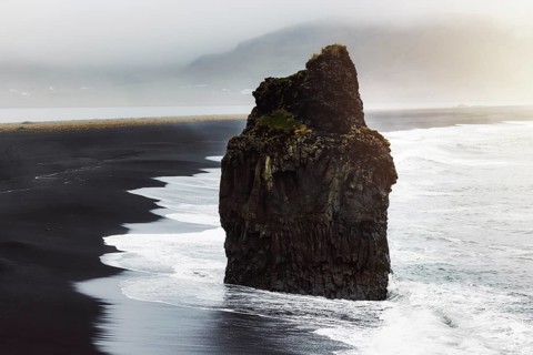 Detail of Arnardrangur rock in the middle of peninsula near Reynisfjara Beach view point Dyrholaey