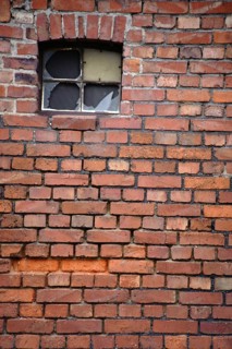 A broken window pane of a disused industrial building