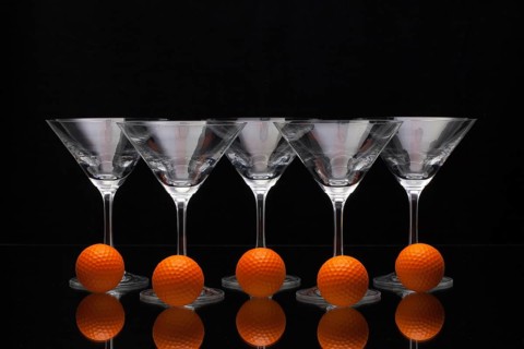 Five glasses of champagne with golf balls