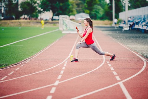 Sports fitness Caucasian women doing warm-up before exercise. Athlete stretching legs doing warm-up