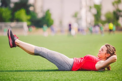 Theme sport and health. Young beautiful Caucasian woman doing warm-up, warming up muscles,
