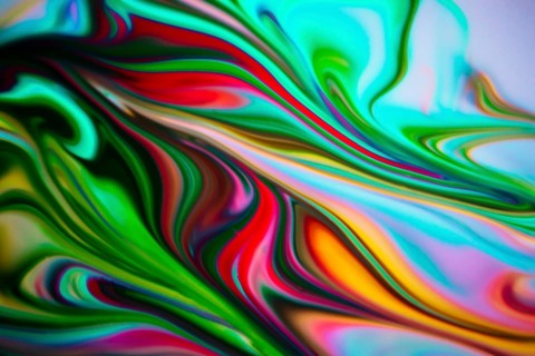 Colorful liquid paints mixed together creating modern abstract