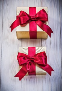 Wrapped present boxes on wooden board holidays concept