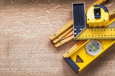 Working tools of measurement on oaken wooden board construction concept