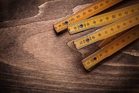 Wooden meter on wood board horizontal image construction concept
