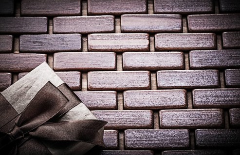 Packed gift box on wooden wicker matting holidays concept