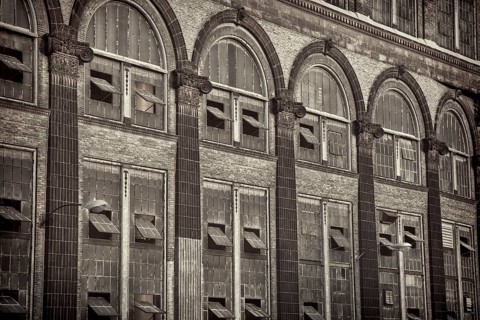 Old power plant - windows and brick walls with sandstone decoration, sepia toned black and white
