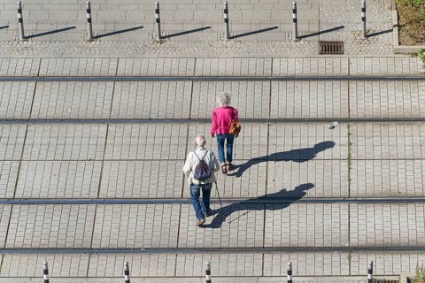 Old pensioner couple on their way through the city centre