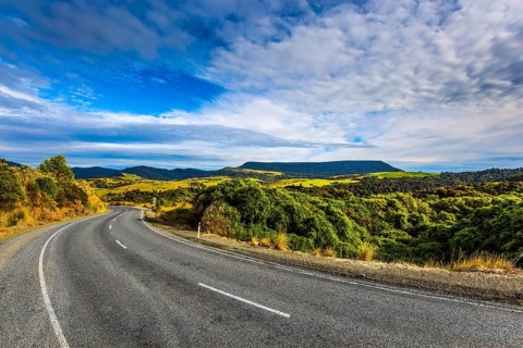 The road to Knight's Point Lookout. Asphalt highway among yellowed autumn vegetation. Picturesque