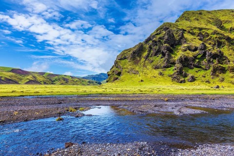 Pakgil Canyon - green grass and moss on the rocks. At the bottom of canyon flows small fast creek.