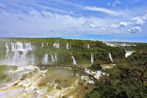 Turbid yellow-brown waves flow down. Raging and roaring water in the Brazilian side of the Iguazu
