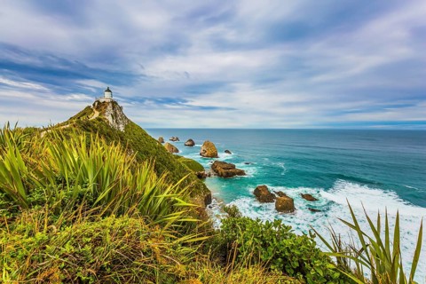 Nugget Point Lighthouse on the cape of the Kathlins coast of the South Island. Travel to New