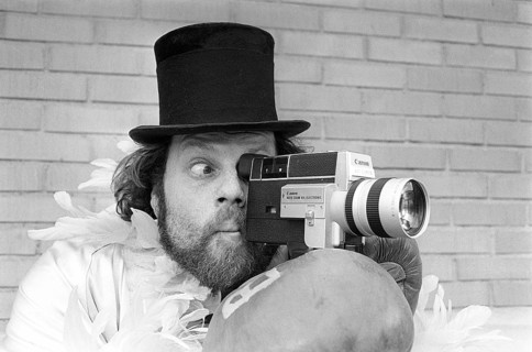 In the 1970s. A man is filming with a amateur film camera. The film was then developed and shown on