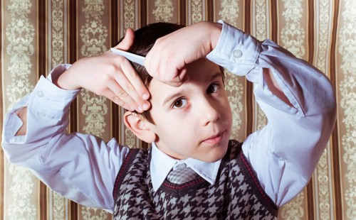 Child vintage clothes decided his hair. Close up shot