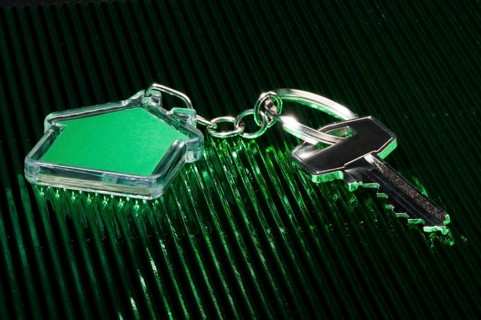 Keychain figure of house and key close up