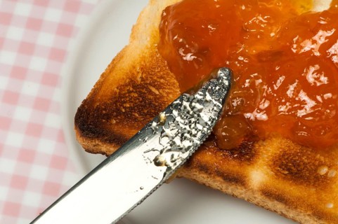 Spread jam on bread with knife