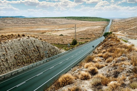 Asphalt road and white line marking. Close up low viewpoint