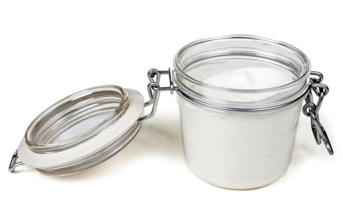 Jar of cream with a steel lock on a white background