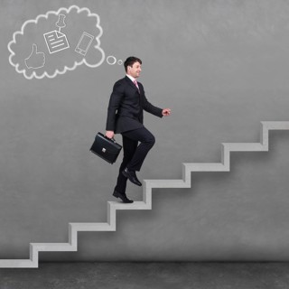 Image of confident businessman with briefcase walking upstairs