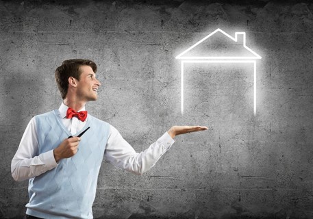 Confident and young businessman smoking pipe and drawn house on gray wall background