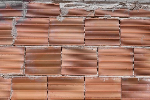 Building brick put in the wall, representing strong european way to build the houses