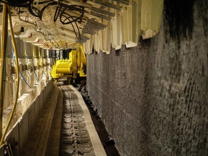 Conveyor belt in tunnel with yellow machine, Bochum, North Rhine-Westphalia, Germany
