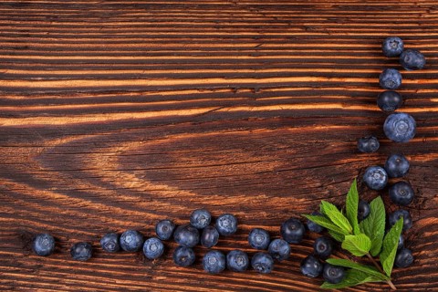 Fresh blueberry background with copyspace. Ripe fresh blueberries on rustic wooden background, top