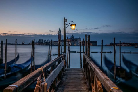Morning atmosphere, Venetian gondolas with the church of San Giorgio Maggiore in the background,