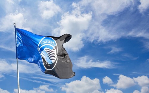 Atalanta flag waving against blue sky with white clouds. Space for text. Bergamo, ITALY - December