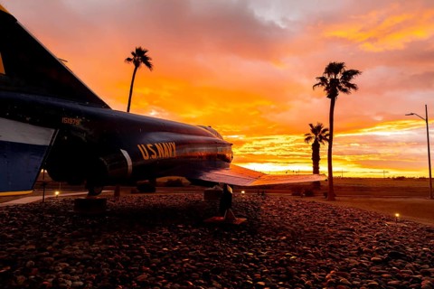 Dawn at Naval Air Field El Centro, CA: Sunlight paints vibrant hues across the sky, casting a