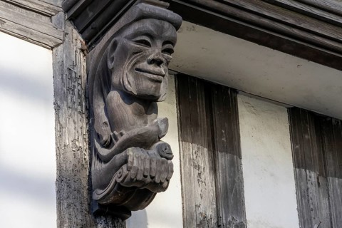Totnes, Devon, UK, January 16. View of a wooden gargoyle in Totnes, Devon on January 16, 2024