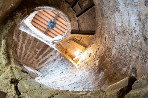 Ancient stairs of snail constructed in stone illuminated by the light of the Sun. Priego de