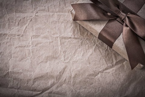 Wrapped present box on wrapping paper holidays concept