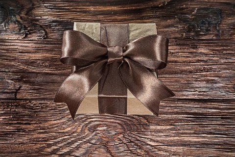 Brown packed gift box on vintage board