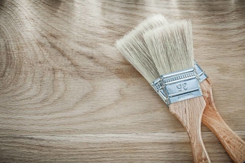 Set of paint brushes on wood board directly above