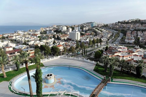 On the way to Ephesus, Lycia, view of urban landscape with swimming pool and palm trees, surrounded