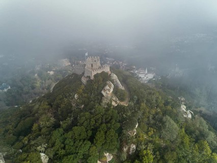 Aerial view of Castelo dos Mouros or Moorish Castle in fog, Sintra, Portugal