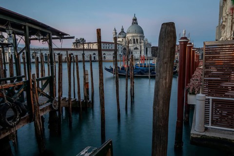 Gondola jetty, Venetian gondolas with the church of Santa Maria della Salute in the background,