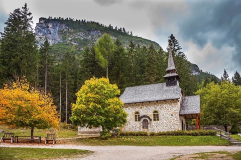 Church on the Alpine lake Lago di Braies. The concept of walking and eco-tourism. Travel to the