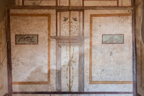 POMPEII, ITALY, MAY 04, 2022, Scenic ancient frescoes in a room of a Pompeiian villa, Southern