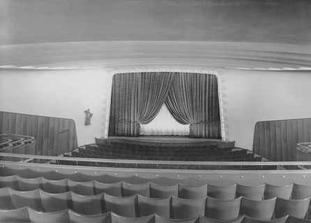 Cinema in the 1940s. An interior of a typical looking movie theatre with seats near the film screen
