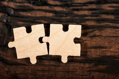Wooden puzzle on dark wooden background
