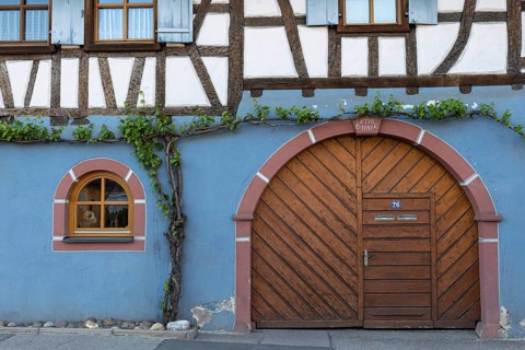 Traditional half-timbered house with wooden door and blue-painted façade, Eichstetten am