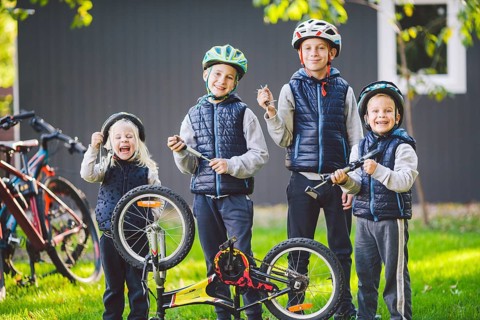 Children mechanics, bicycle repair. Happy kids fixing bike together outdoors in sunny day. Bicycle