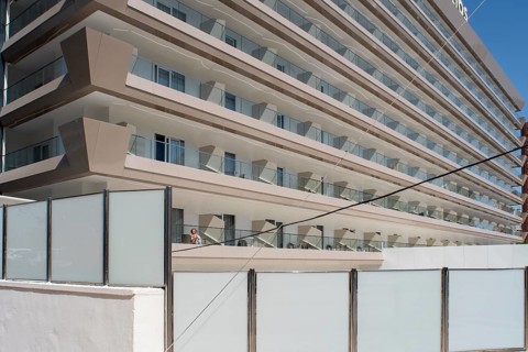 Woman sunbathing on the balcony of Hotel Helios in Benidorm, Alicante province, Spain