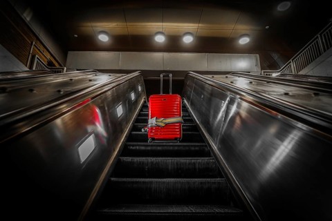 Escalator and suitcase. Shooting Location: New York, Manhattan